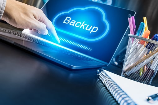 Businessman hand using modern laptop with Cloud Backup concept